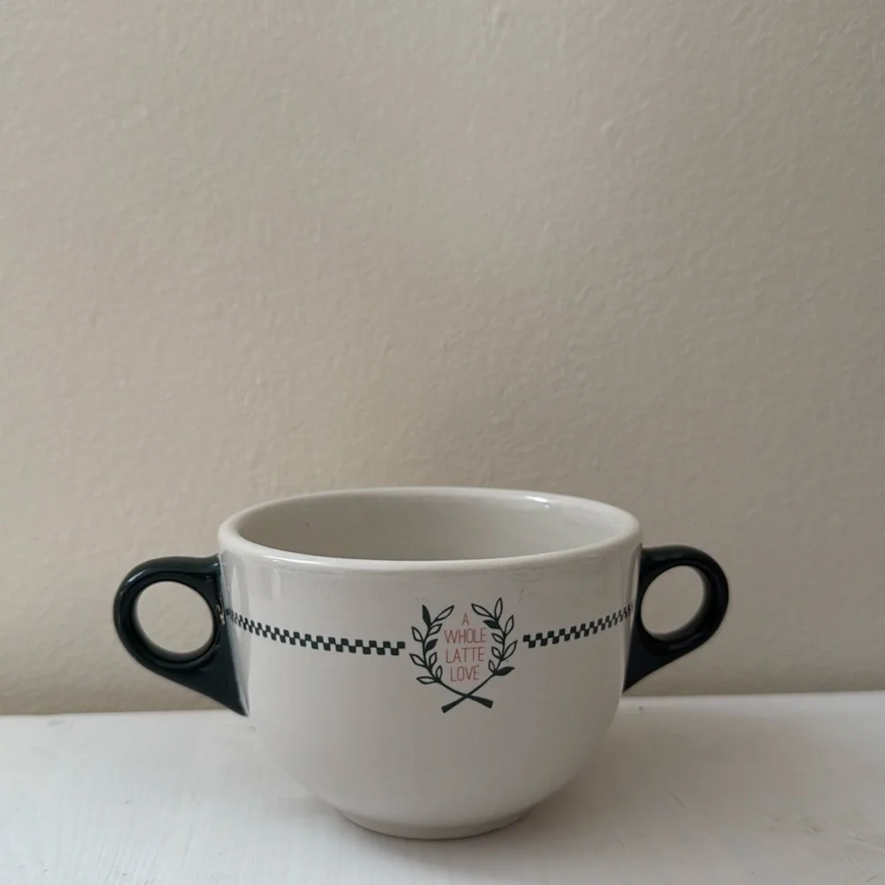 Bowl style mug with two handles. Font reads “a whole latte love”